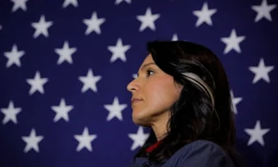 a woman in front of an american flag