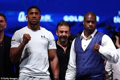 Usyk was due to fly to London to watch Anthony Joshua (left) take on Daniel Dubois (right)