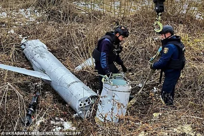 In this handout photograph taken and released by the Ukrainian Emergency Service on November 28, 2024, Ukrainian rescuers prepare to load the remains of a Russian X-55 cruise missile onto a truck