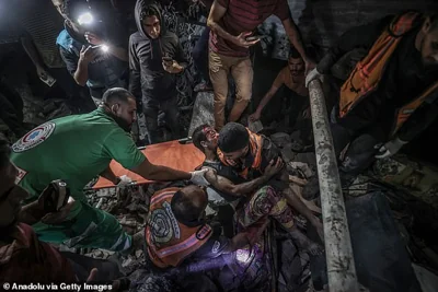 Civil defense members rescue injured people from the debris of a building after Israeli attacks hit the house of Jaber family in Deir Al Balah, Gaza on October 04, 2024