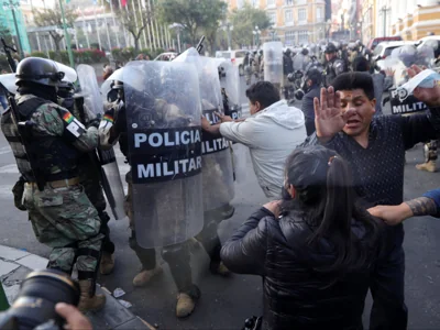 Followers of Bolivian President Luis Arce protest against military personnel trying to enter the government headquarters in La Paz