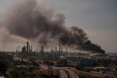 Smoke billows from an oil production facility.