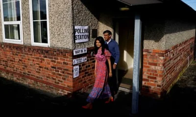 Sunak and Murty emerge from a polling station