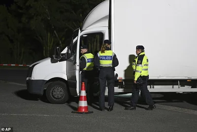 Police officers check a van at the Bunderneuland border crossing early on Monday morning