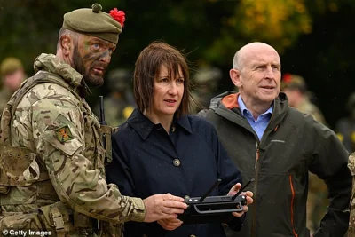 Rachel Reeves (C) operates a drone with Defence Secretary John Healey at the Stanford Training Area near Thetford on October 20