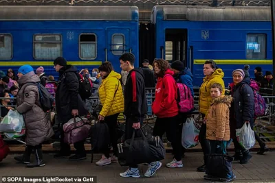 Crowds of refugees from Mariupol make their way out of the Lviv train station on the eve of the war in 2022