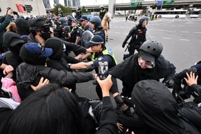 Victorian police and protesters face off during a rally against the Land Forces International Land Defence Exposition at the Melbourne Convention and Entertainment Centre.