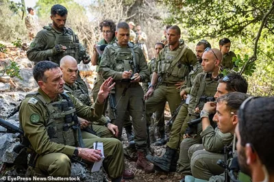 Major General Herzi Halevi (left) visits troops on the northern border on Wednesday