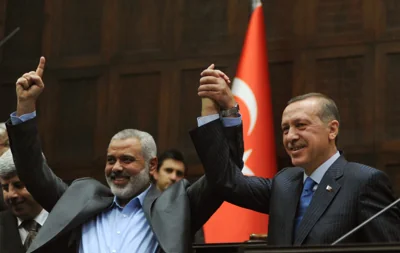 Files: The Gaza Strip's Hamas prime minister Ismail Haniyeh (L) and his Turkish counterpart Recep Tayyip Erdogan salute together the lawmakers of Erdogan's Islamic-rooted Justice and Development Party at the Parliament in Ankara on 3 January 2012. The Palestinian militant group Hamas said on 31 July 2024, its political leader Haniyeh was killed in an Israeli strike in Iran and vowed the act "will not go unanswered"