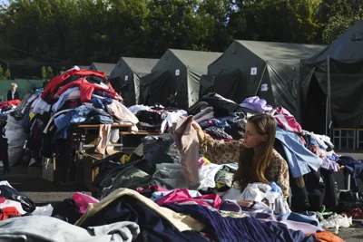 Woman chooses clothes after evacuating