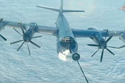 A Russian TU-95 bomber is refuelled during joint Russian and Chinese military plane patrols