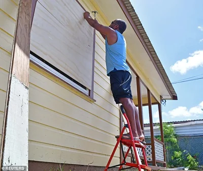 A man boards up a house ahead of the arrival of Hurricane Beryl in Bridgetown, Barbados June 30, 2024