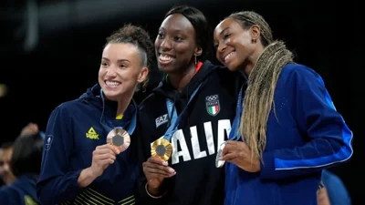 From left Gabriela Braga of Brazil, Paola Egonu of Italy and Chiaka Ogbogu of the United States, show their medals after ceremony at the end of the women's volleyball final at the 2024 Summer Olympics(AP)