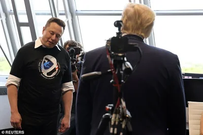 Elon Musk gives a small bow of the head as U.S. President Donald Trump congratulates him at the Firing Room Four after the launch of a SpaceX Falcon 9 rocket and Crew Dragon spacecraft on NASA's SpaceX Demo-2 mission to the International Space Station from NASA's Kennedy Space Center in Cape Canaveral, Florida, U.S. May 30, 2020