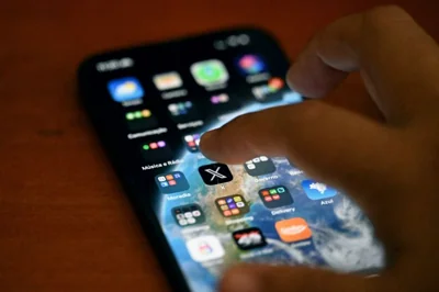 Someone about to tap on the X app on the screen of a smartphone