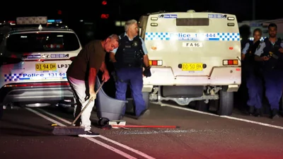 Cleanup crews sweep broken glass after mob attacks police in Sydney following church stabbing