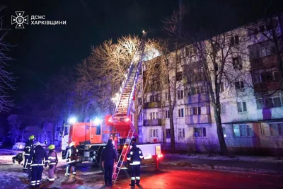 In this photo provided by the Ukrainian Emergency Service, firefighters work on the site of a damaged building after a Russian drone attack in Kharkiv, Ukraine