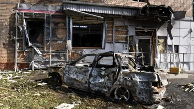 Building and car damaged after shelling by the Ukrainian side in Kursk, Russia