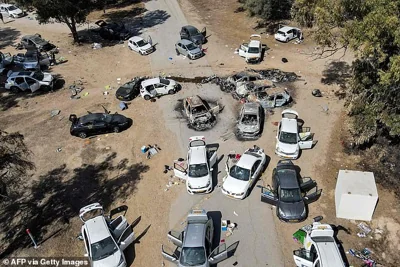 This aerial picture shows abandoned and torched vehicles at the site of the October 7 attack on the Supernova desert music Festival by Palestinian militants near Kibbutz Reim in the Negev desert in southern Israel on October 13, 2023