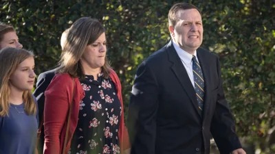 Former Portage Mayor James Snyder walks to court with his family wearing a dark suit