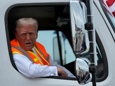 Donald Trump boards garbage truck, addresses rally dressed as garbage collector