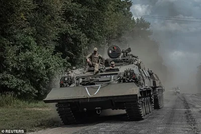 Ukrainian servicemen ride a military vehicle, amid Russia's attack on Ukraine, near the Russian border in Sumy region, Ukraine on August 10