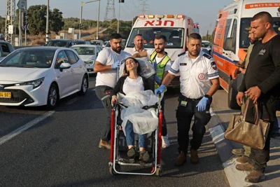 First responders transport a woman following a rocket attack from Lebanon near Kiryat Ata in northern Israel on Oct. 31, 2024.