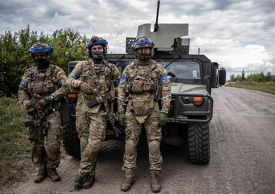 Ukrainian troops pose with a humvee during the invasion