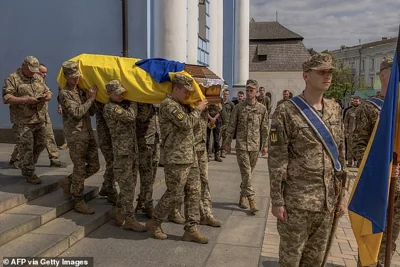 Ukrainian soldiers carry the coffin of Ukrainian serviceman who was killed in the Donetsk region