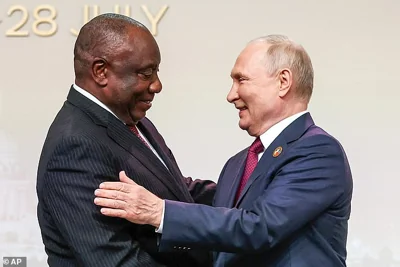 South African President Cyril Ramaphosa, left, and Russian President Vladimir Putin shake hands in St. Petersburg, Russia