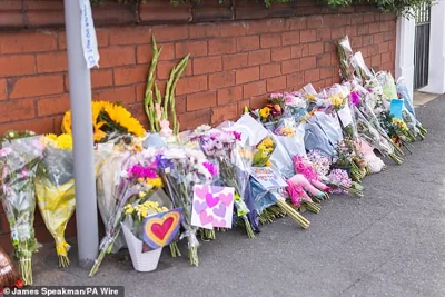 Floral tributes near the scene in Southport today after two children died and nine were injured