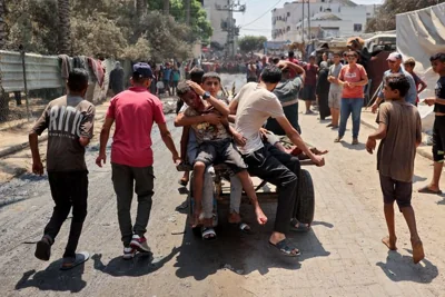 Palestinians injured during an Israeli strike on the Khadija school housing displaced people, ride on the back of a cart in Deir al-Balah, in the central Gaza Strip on July 27, 2024, amid the ongoing conflict between Israel and the militant Hamas group. (Photo by EYAD BABA/AFP via Getty Images)