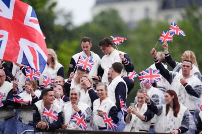 Team GB athletes, including Sir Andy Murray (centre, back), smile through the rain during the Paris Olympics opening ceremony (John Walton/PA).