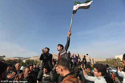 People in Damascus celebrate on December 9, 2024, after Islamist-led rebels declared that they have taken the Syrian capital in a lightning offensive