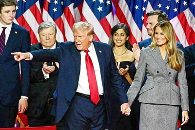 A SECOND TERM Former US president Donald Trump gestures at supporters after speaking as he holds hands with former US first lady Melania Trump during an election night event at the West Palm Beach Convention Center in West Palm Beach, Florida, early on Nov. 6, 2024. PHOTO BY JIM WATSON/AFP