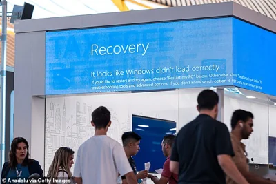 A large blue screen is shown at Madrid Barajas airport in Spain, as the major IT outage saw flights thrown into chaos worldwide