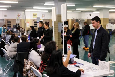 People gather at Nathan Straus Elementary School to vote in New York City