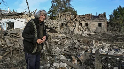 A woman stands in the backyard of her house destroyed by a Russian air strike, amid Russia's attack on Ukraine, in Zaporizhzhia, Ukraine, Oct. 10, 2024. Reuters/Stringer