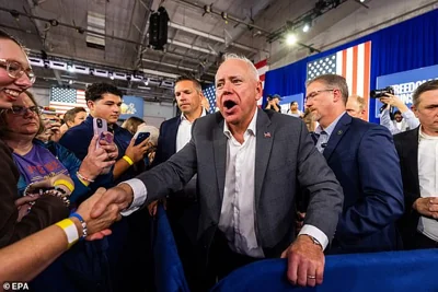 Minnesota Governor and Democratic Vice Presidential nominee Tim Walz (C) greets supporters at a campaign rally,