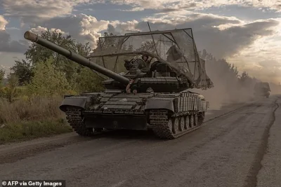 Ukrainian servicemen drive Soviet-made T-64 tanks in the Sumy region, near the border with Russia, on August 11, 2024