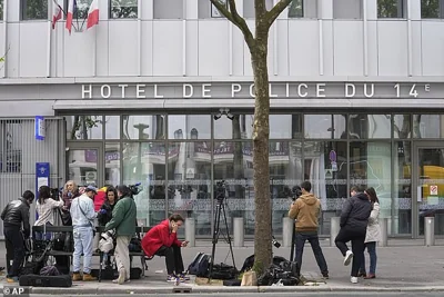 Reporters wait outside the police station where French actor Gerard Depardieu is being questioned