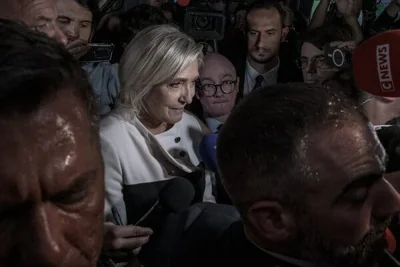 Marine Le Pen was surrounded by reporters as she spoke. 