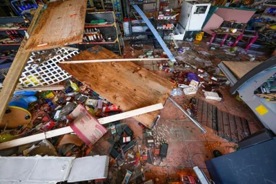 Liquor and beer bottles are seen strewn inside of Swami Spirits, in the aftermath of the storm surge from Hurricane Helene, in Cedar Key, Fla., Sept. 27. AP-Yonhap