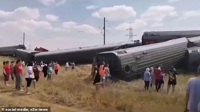 Shocked onlookers gather around the train as people rushed to help those trapped inside