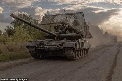 Ukrainian servicemen drive Soviet-made T-64 tanks in the Sumy region, near the border with Russia, on August 11