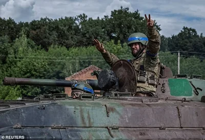 Ukrainian servicemen ride a BMP-1 infantry fighting vehicle near the border in Sumy, Ukraine