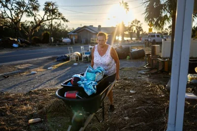 Melinda Segassie wheels some items that she deemed salvageable from her home which had been flooded by Hurricane Helene, in Steinhatchee, Florida, U.S., September 29, 2024. REUTERS/Kathleen Flynn TPX IMAGES OF THE DAY