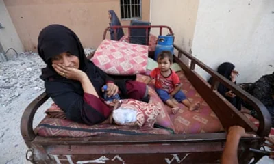 A woman and child who fled Khan Younis take shelter in the open air