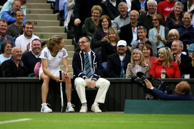 Steffi Graf stops for a chat with a line judge on Centre Court in 2009