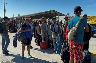 Migrants lined up to board buses in Tehuantepec, Mexico to other parts of the country after participating in caravans. They received help from Mexico's National Migration Institute